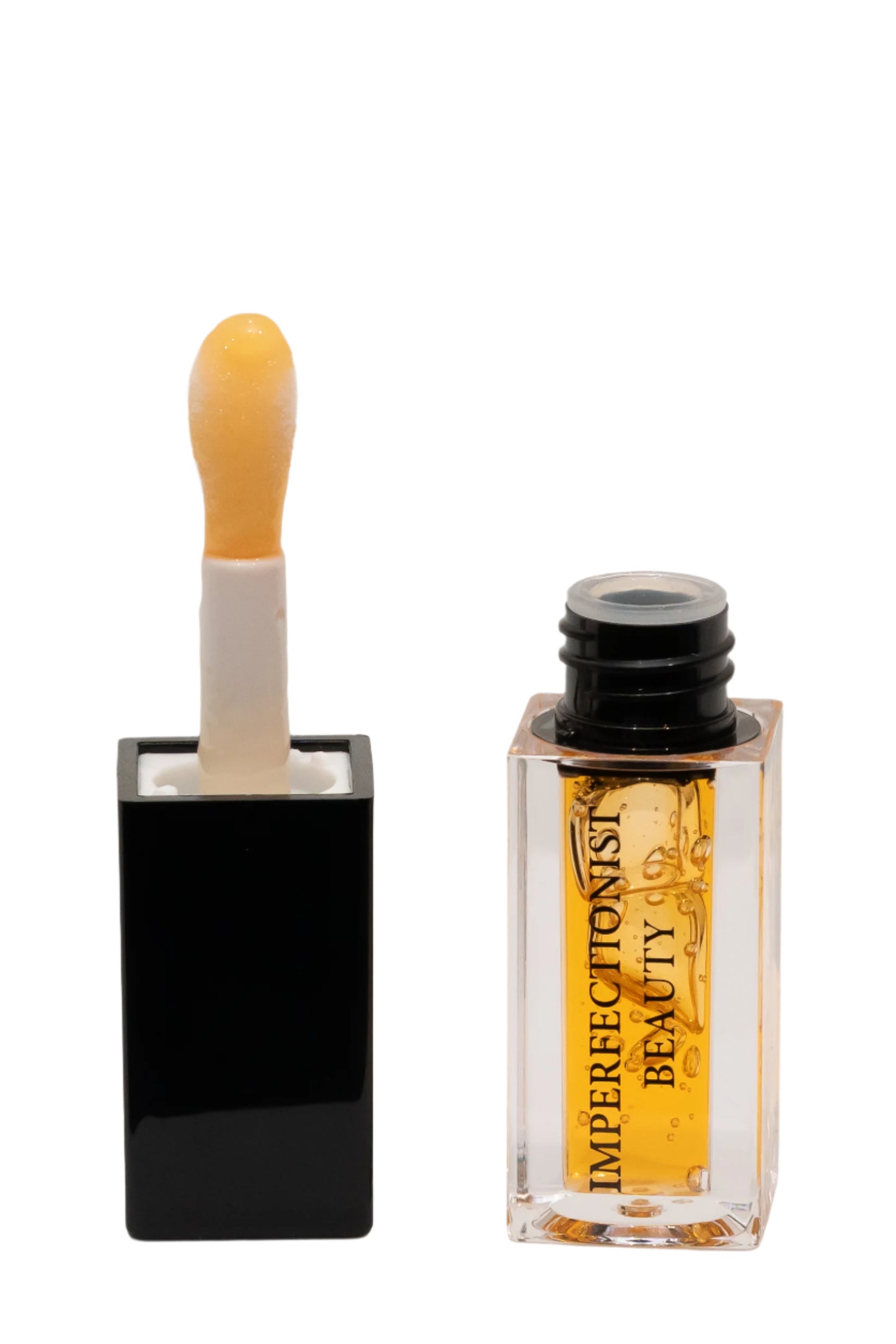 Beauty product with a dropper and a small bottle labeled 'Imperfectonist Beauty' on a white background
