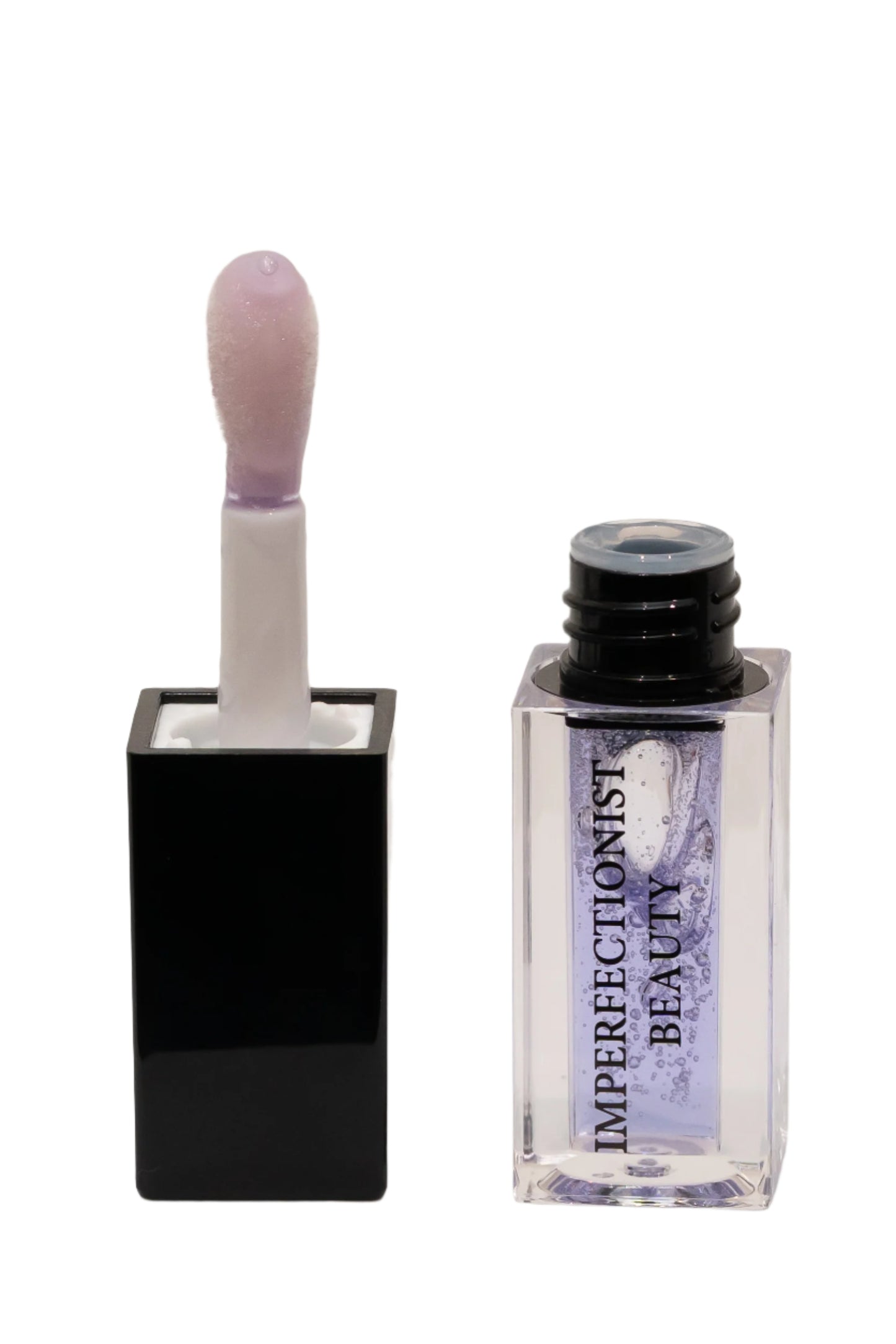 Lip gloss with applicator and container labeled 'Imperfectionist Beauty' on a light background